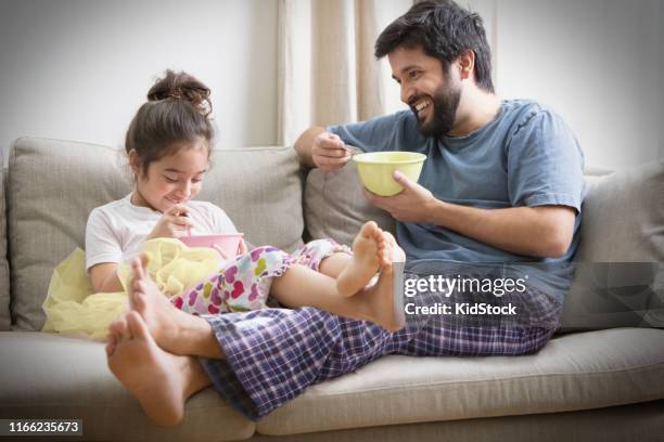 father and daughter having cereals for breakfast - kidstock girl stock pictures, royalty-free photos & images