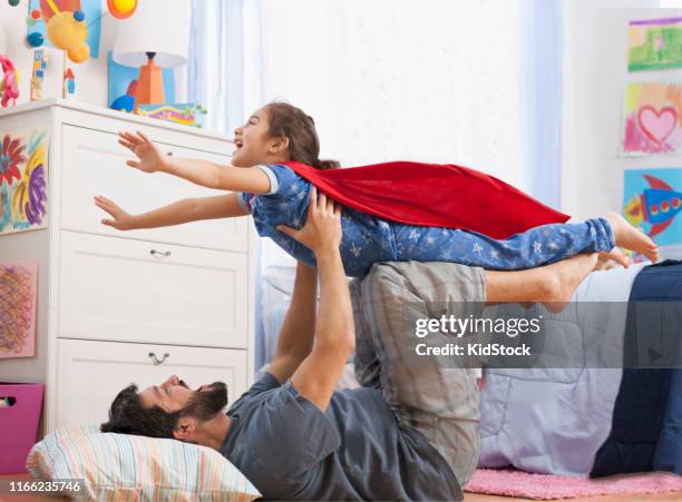 father and daughter wearing a superhero costume - kidstock girl stock pictures, royalty-free photos & images