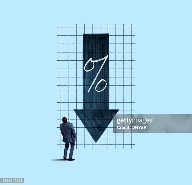 businessman looking up at falling interest rates - interest rate stock pictures, royalty-free photos & images