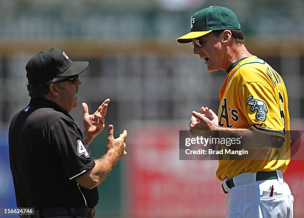 Manager Bob Melvin of the Oakland Athletics argues with third base umpire Tim Tschida after being ejected during the game against the Kansas City...