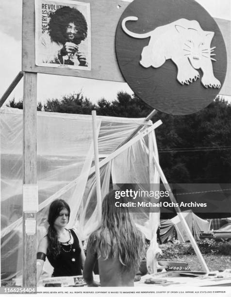 Attendees at the White Panther Party booth at the Woodstock Music Festival on August 16, 1969 in Woodstock, New York.