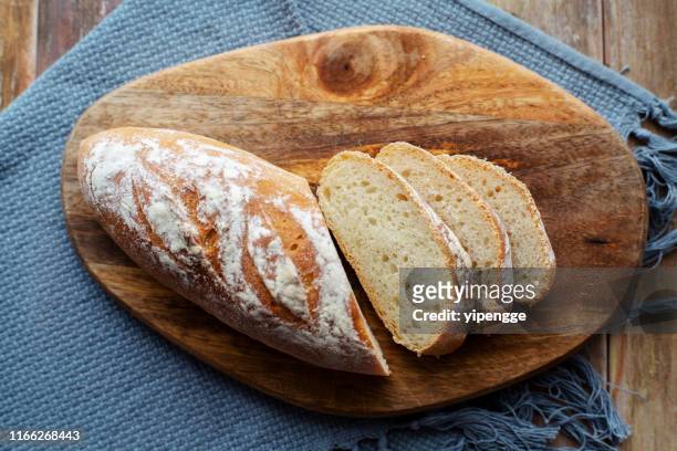 homemade wholegrain bread slices - chopping block flour stock pictures, royalty-free photos & images