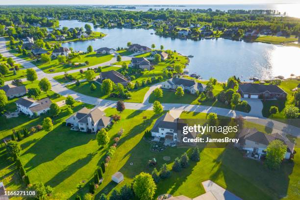 beautiful waterfront homes on lake at sunrise in summertime. - idyllic community stock pictures, royalty-free photos & images