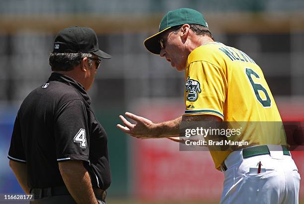 Manager Bob Melvin of the Oakland Athletics argues with third base umpire Tim Tschida after being ejected during the game against the Kansas City...