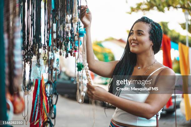 black woman looking and choosing crafts at olinda fair - craft stock pictures, royalty-free photos & images