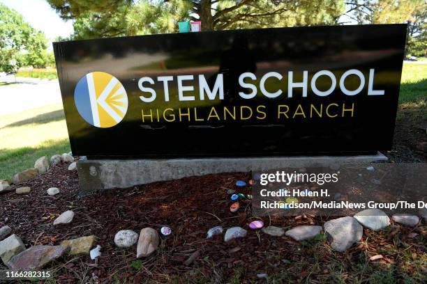 Hand painted rocks are placed next to the Stem School sign at STEM School on August 5, 2019 in Highlands Ranch, Colorado. Classes start for students...