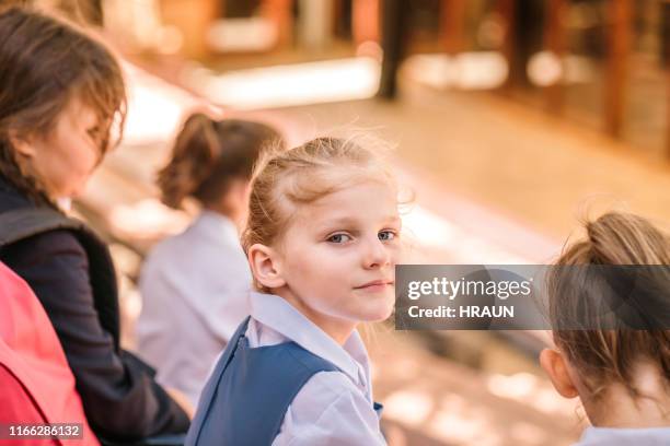 portrait of cute girl with friends outside school - girl who stands stock pictures, royalty-free photos & images