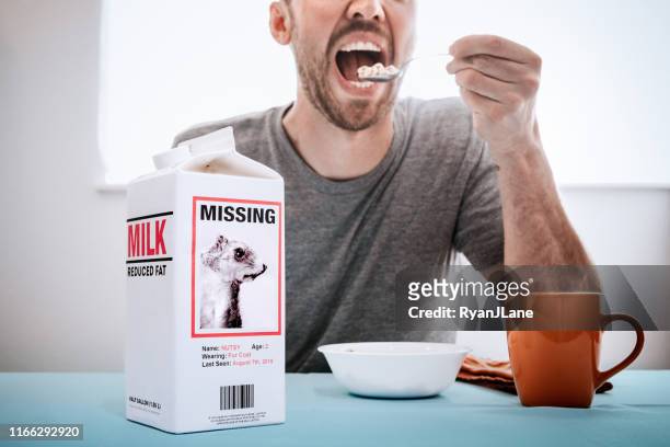 missing person milk carton with squirrel while man eats breakfast - milk carton stock pictures, royalty-free photos & images