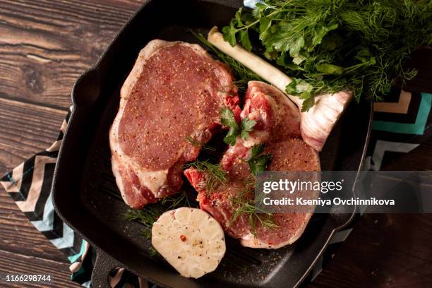 raw fresh marbled meat beef on a grill pan ready for cooking on a blue concrete background top view - food photography dark background blue stock pictures, royalty-free photos & images