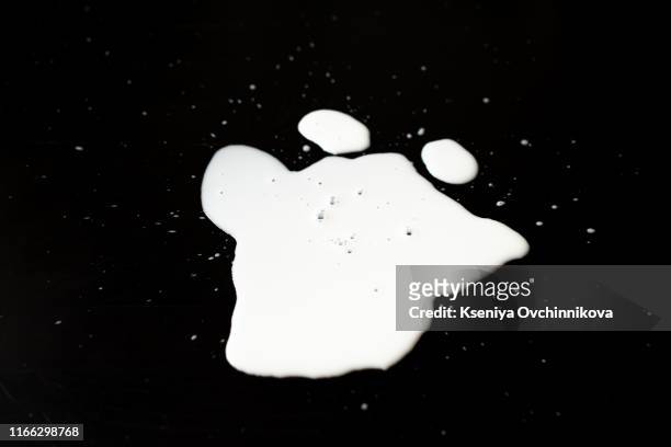 spilled milk puddle isolated on black background and texture with clipping path, top view - dripping milk stock pictures, royalty-free photos & images