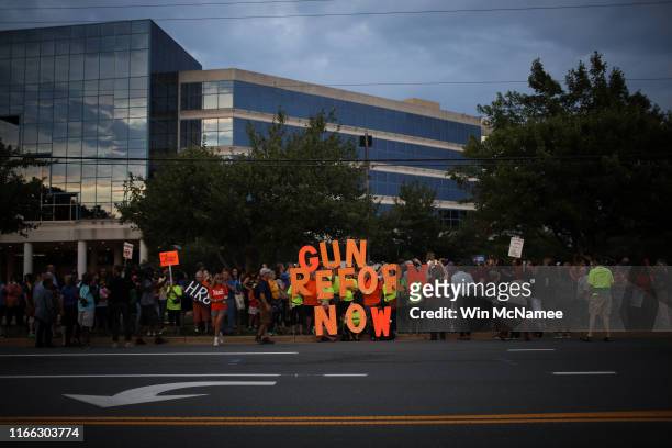 Advocates of gun reform legislation hold a candle light vigil for victims of recent mass shootings outside the headquarters of the National Rifle...