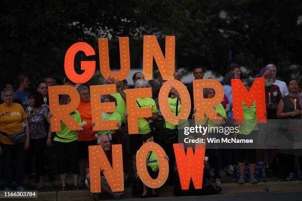 Advocates of gun reform legislation hold a candle light vigil for victims of recent mass shootings outside the headquarters of the National Rifle...