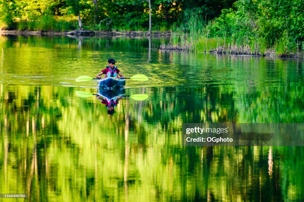 Young Hispanic boy kayaking