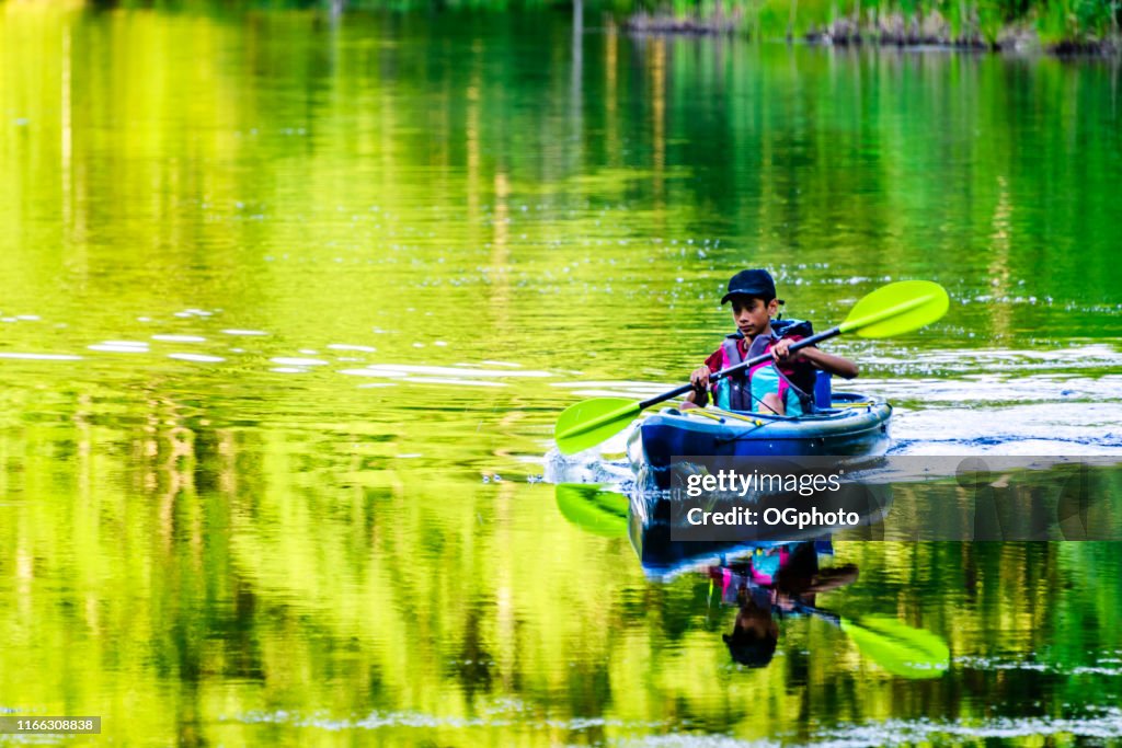 Young Hispanic boy kayaking