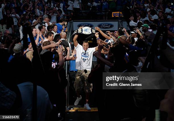Shawn Marion of the Dallas Mavericks holds up a Mavericks "Championship Belt" as he is introduced to the crowd during the Mavericks NBA Champion...