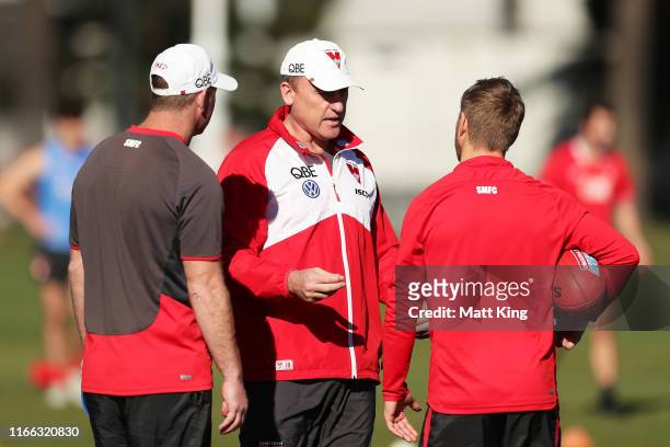 Swans coach John Longmire talks to Kieren Jack and assistant coach Steve Johnson during a Sydney Swans AFL training session at Lakeside Oval on...