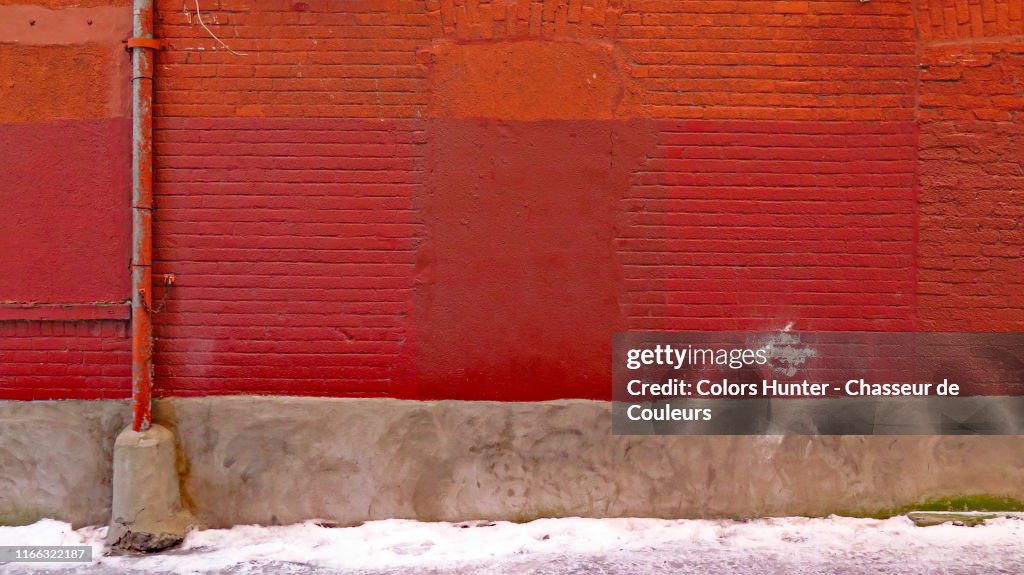 Montreal old brick wall with pipe and snow