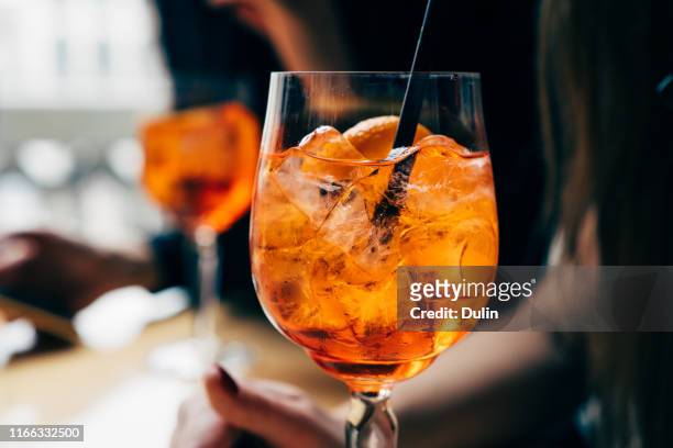 two women with spritz drinks - happy hour stockfoto's en -beelden