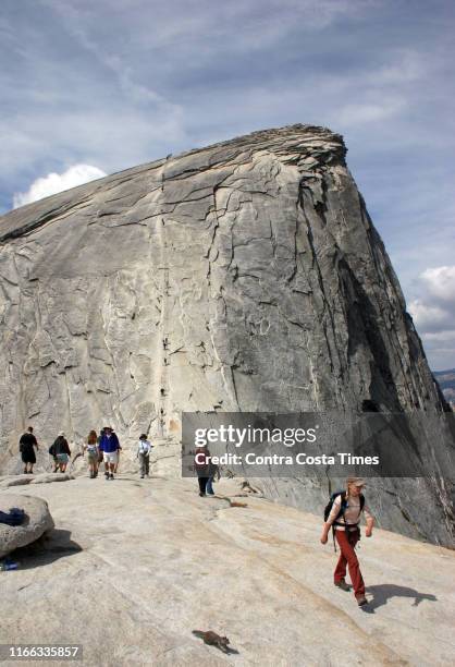 The top of Half Dome and its 400 feet of vertical cables, as seen on Aug. 23 in Yosemite National Park in California. A hiker has died after she fell...