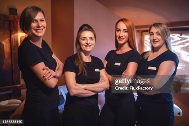 team of female massage therapists - massager stock pictures, royalty-free photos & images