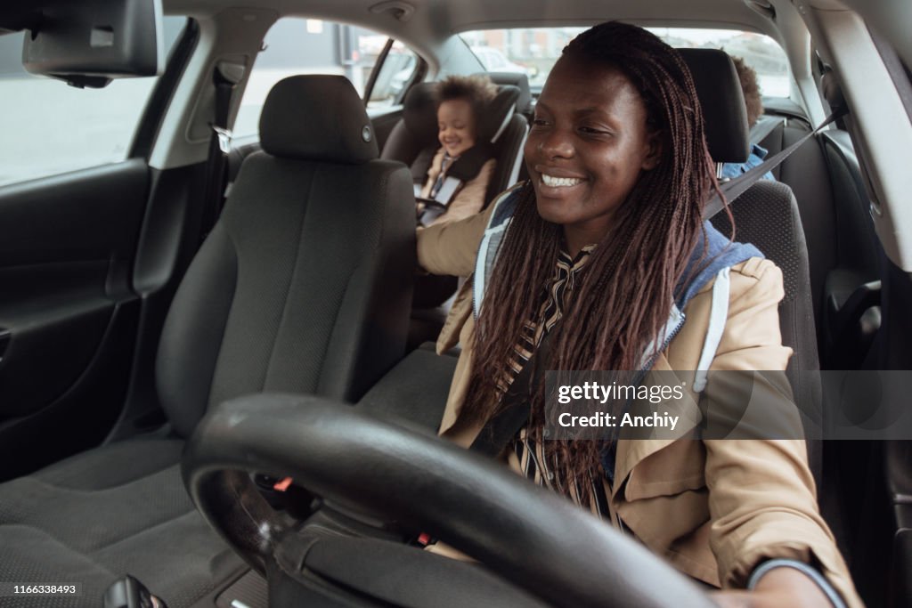 Mother driving kids to school