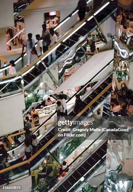 shopping amid escalators, new world shopping - shopping centre escalator stock pictures, royalty-free photos & images