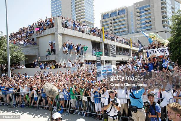 Fans of the Dallas Mavericks hang out of every window and off of every balcony during the Mavericks NBA Champion Victory Parade on June 16, 2011 at...