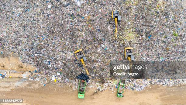 garbage factory at the cityscape - landfill stock-fotos und bilder