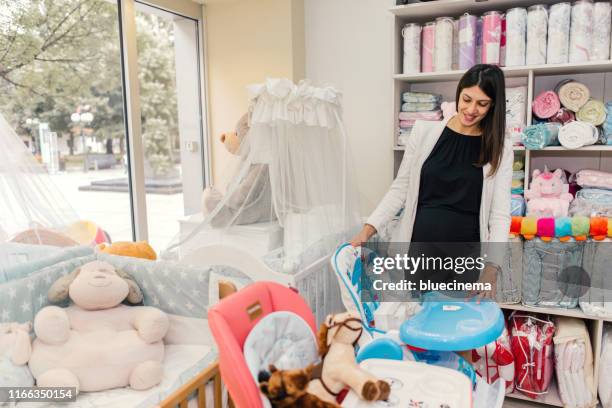 pregnant woman shopping - baby boutique stock pictures, royalty-free photos & images