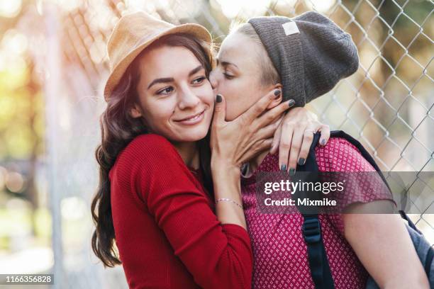charming female couple dating in the city - lesbians kissing stock pictures, royalty-free photos & images