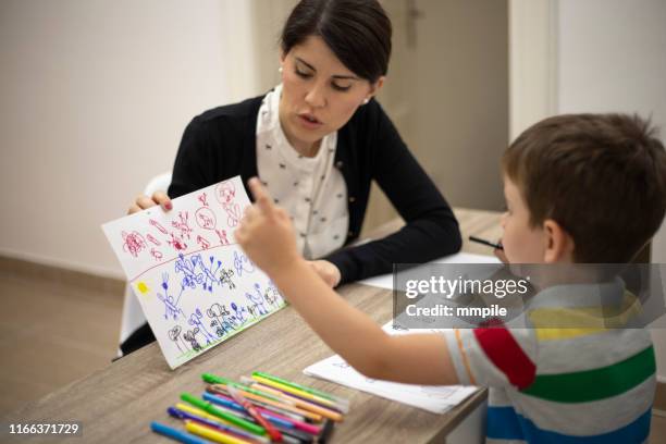 finding symbols in his drawings - child psychologist stock pictures, royalty-free photos & images