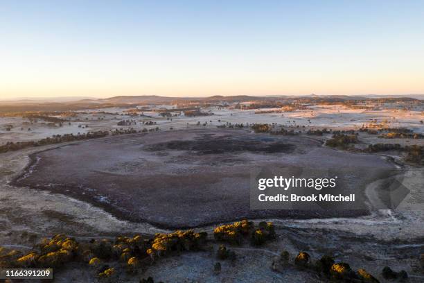 Frost covers the now empty Little Llangothlin lagoon near the town of Guyra. The lagoon is part of a string of protected wetlands, internationally...