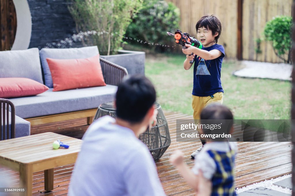 Boy playin water pistol fight