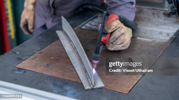 welder is welding tungsten inert gas welding. - alloy stock pictures, royalty-free photos & images