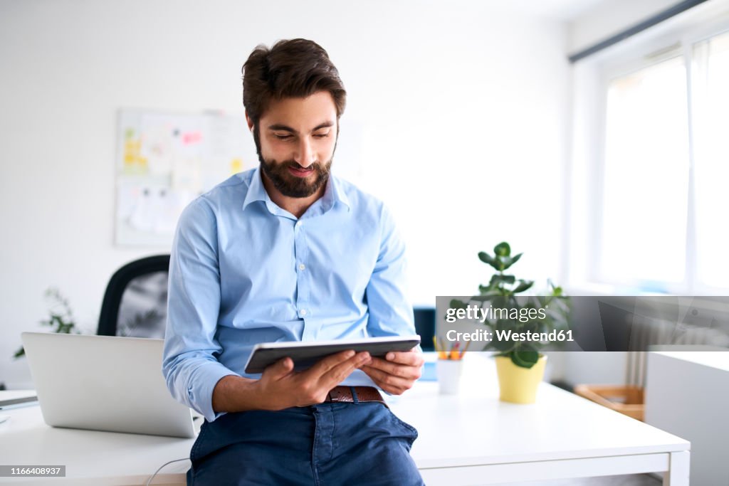 Businessman using a digital tablet in his office