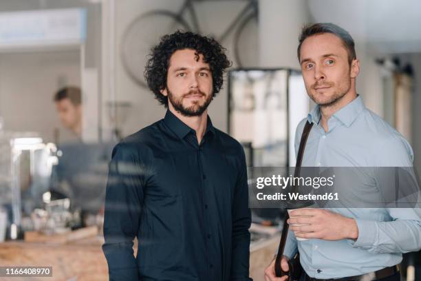 two businessmen standing in a coffee shop - customer appreciation stock pictures, royalty-free photos & images