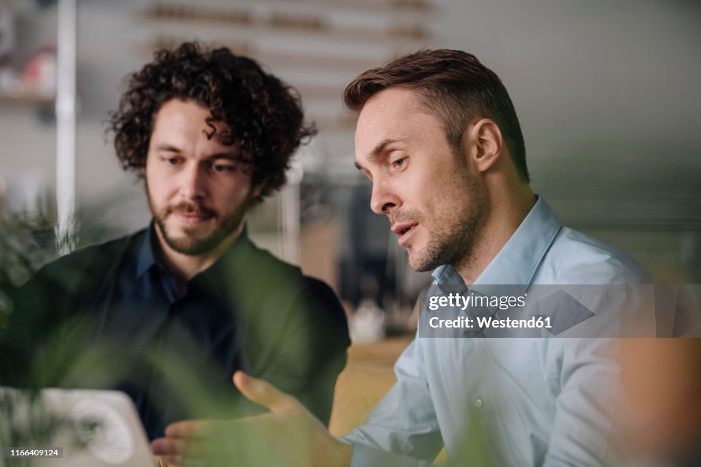 Two businessmen having a meeting in a coffee shop