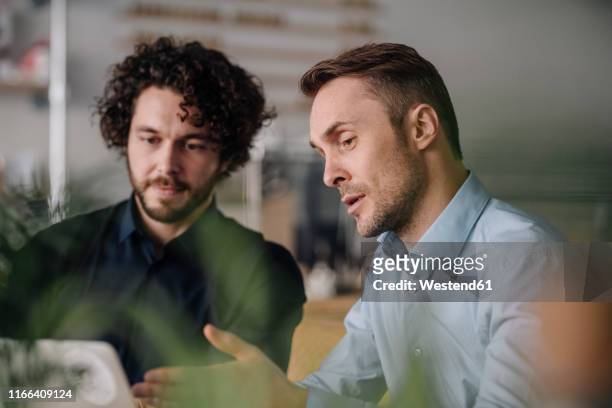 two businessmen having a meeting in a coffee shop - two executive man coffee shop stock pictures, royalty-free photos & images