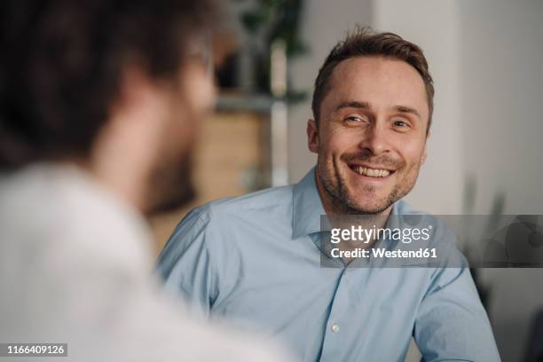 two businessmen having a meeting in a coffee shop - two executive man coffee shop stockfoto's en -beelden