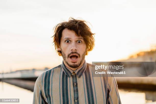 portrait of staring man at sunset - scared man portrait stock pictures, royalty-free photos & images