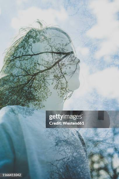 double exposure of girl and sky with trees and clouds - mehrfachbelichtung stock-fotos und bilder