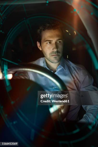 businessman in car at night surrounded by virtual tachometer - augmented reality car stockfoto's en -beelden