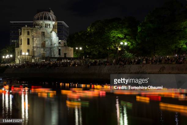 Candle lit paper lanterns are seen on the river during an event to commemorate the 74th anniversary of the atomic bombing of Hiroshima at the...