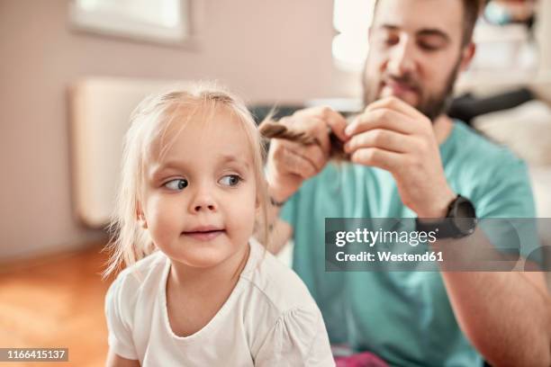 father braiding hair of his daughter - braids stock pictures, royalty-free photos & images