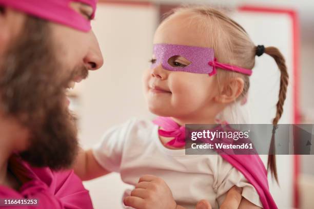 father and daughter playing super hero and superwoman - superwoman stock pictures, royalty-free photos & images