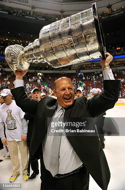 Head coach Claude Julien of the Boston Bruins celebrates as he lifts the Stanley Cup after his team defeated the Vancouver Canucks 4-0 in Game Seven...