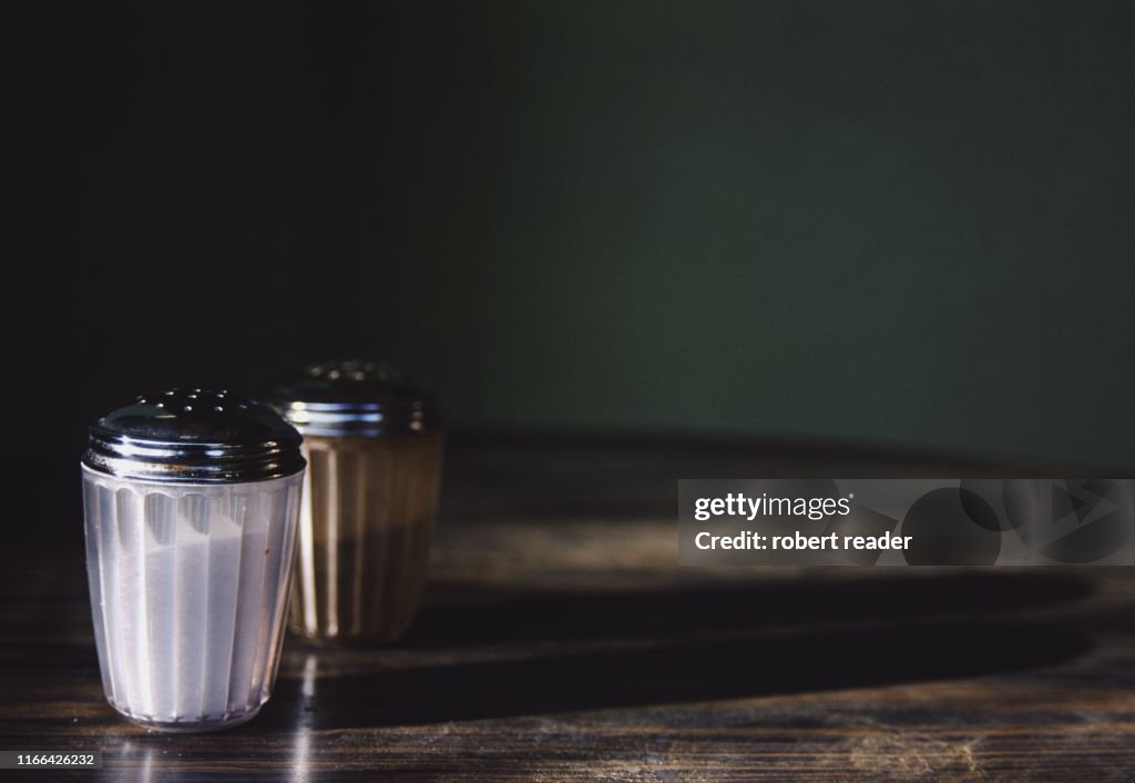 Salt and pepper on wooden table