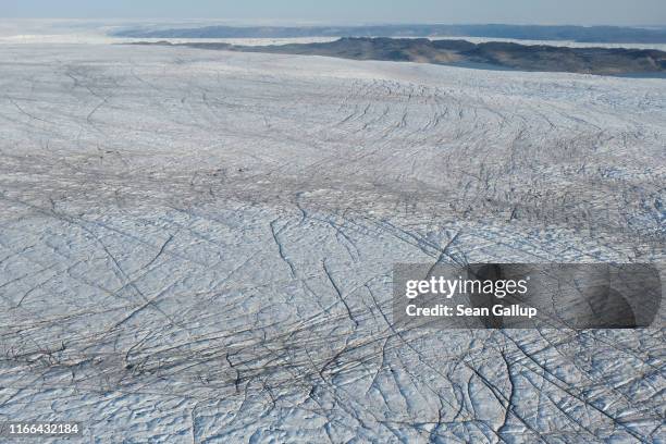 In this view from an airplane the Greenland ice sheet lies near the Sermeq Kujalleq glacier , also called the Jakobshavn glacier, on August 04, 2019...