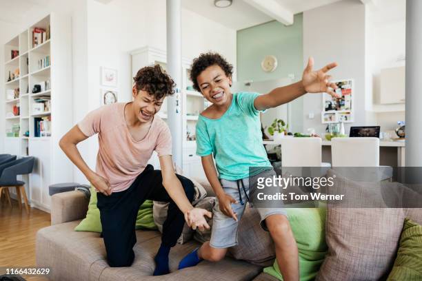 Two Brothers Messing Around Having Fun At Home