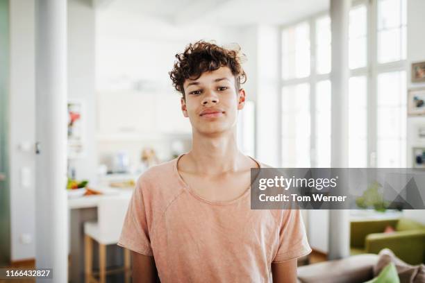 portrait of young boy at home - curly hair man stock pictures, royalty-free photos & images